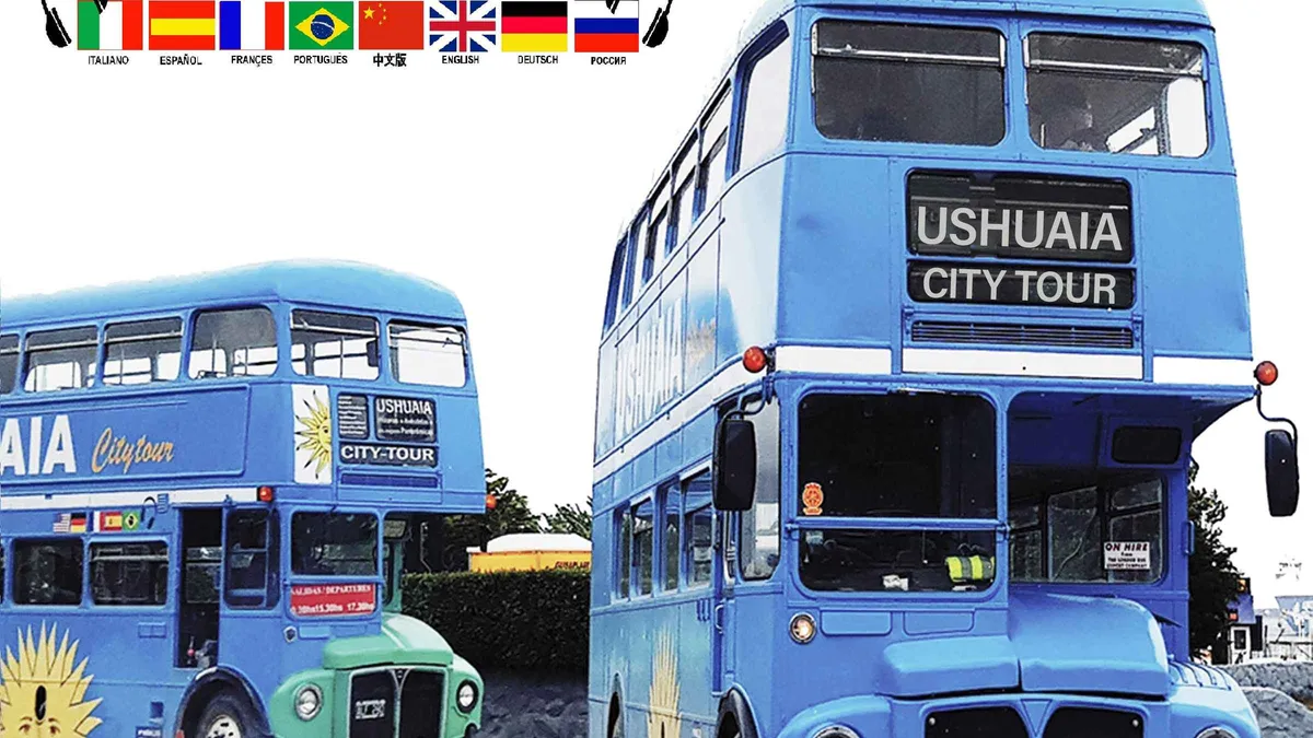 Open-top doubledecker bus on the coastal avenue of Ushuaia with the Martial mountains behind, Argentina